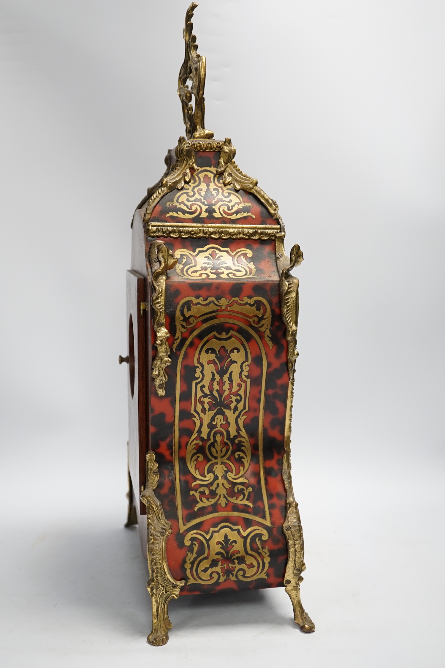 A simulated tortoiseshell Boulle work mantel clock, striking on a bell, 57cm high